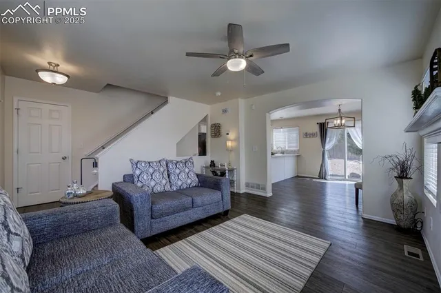 a living room with furniture and a chandelier