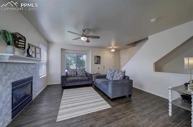 a living room with hard wood floors and a fireplace