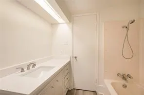 an empty room with a ceiling fan and a window