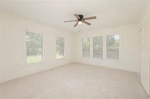 a view of a room with a window and a ceiling fan