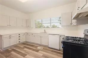 a kitchen with refrigerator and cabinets