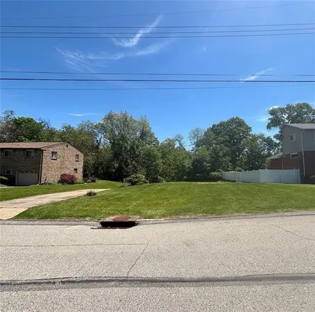 a view of a house with a yard and a car parked in it