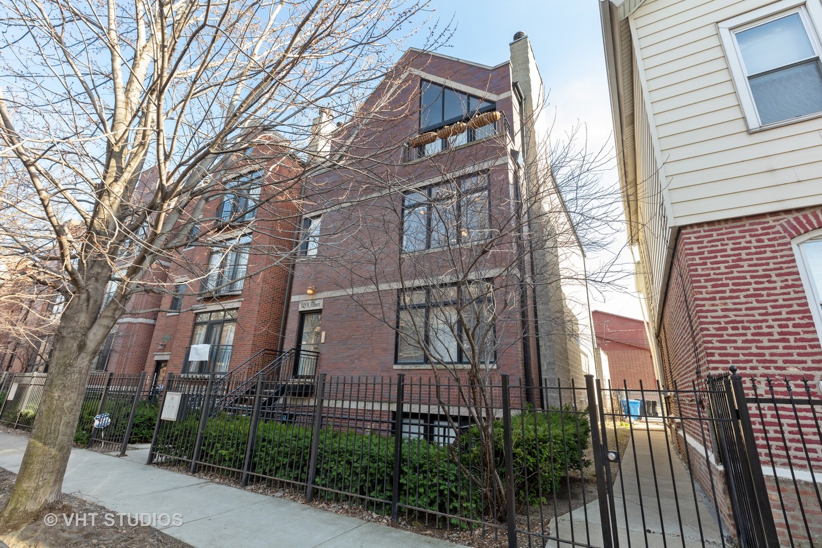 a view of a brick building next to a yard