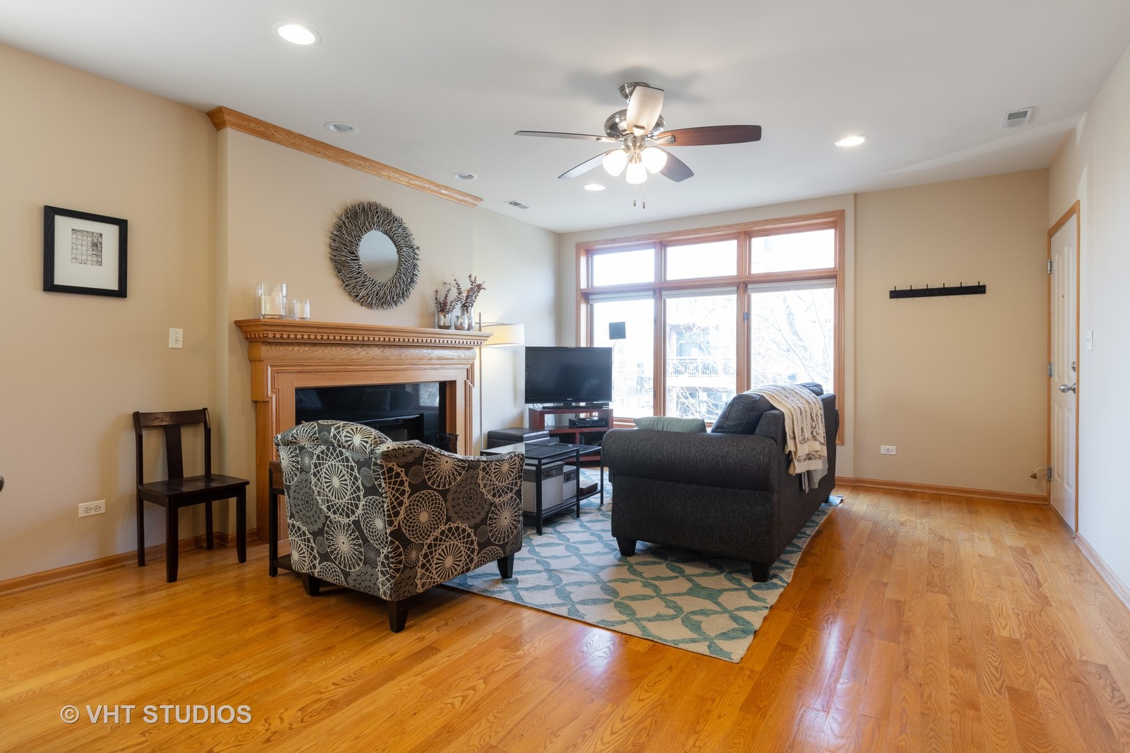 1429 West Fillmore Street, Unit 2 Chicago, IL 60607 - Photo 2 of 14 a living room with furniture and a fireplace
