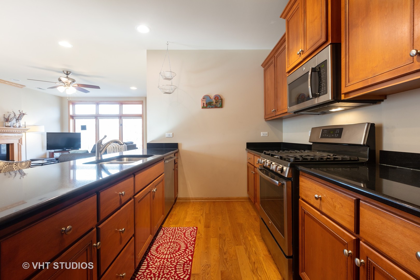 1429 West Fillmore Street, Unit 2 Chicago, IL 60607 - Photo 7 of 14 a kitchen with stainless steel appliances granite countertop a stove and a sink