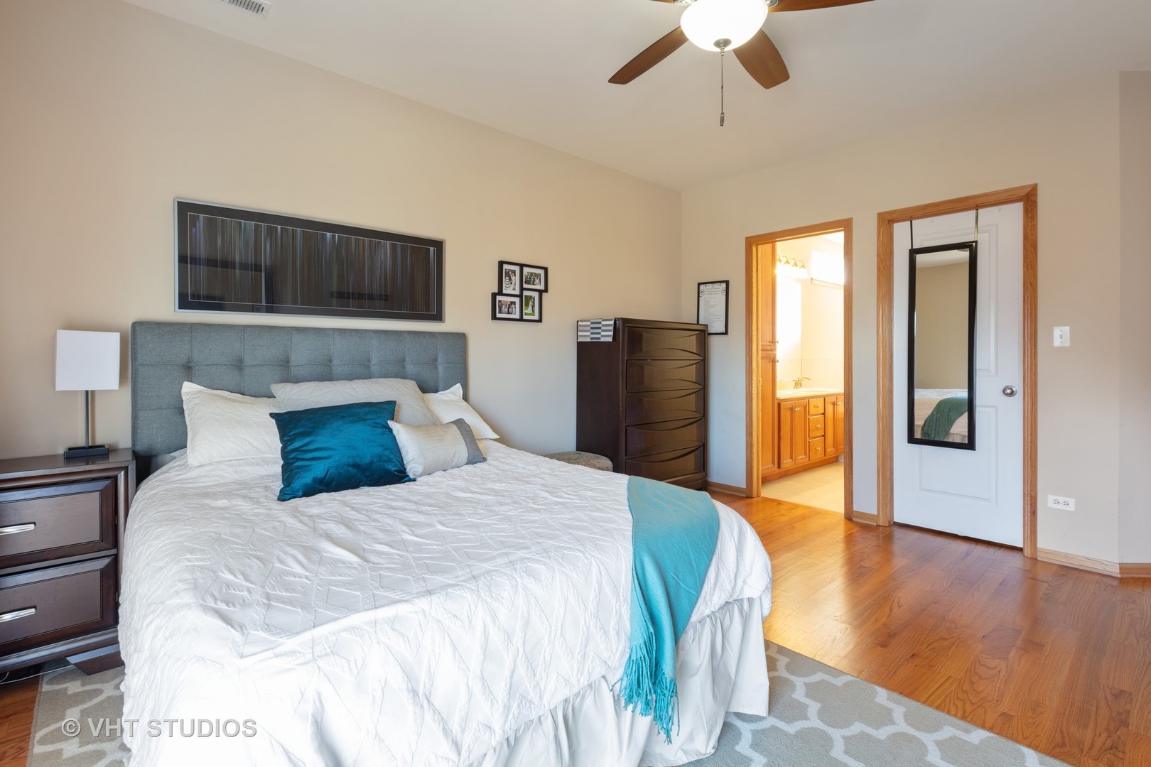 1429 West Fillmore Street, Unit 2 Chicago, IL 60607 - Photo 9 of 14 a bedroom with a bed and wooden floor