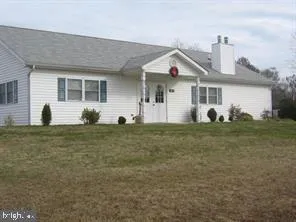 a view of a white house with a yard