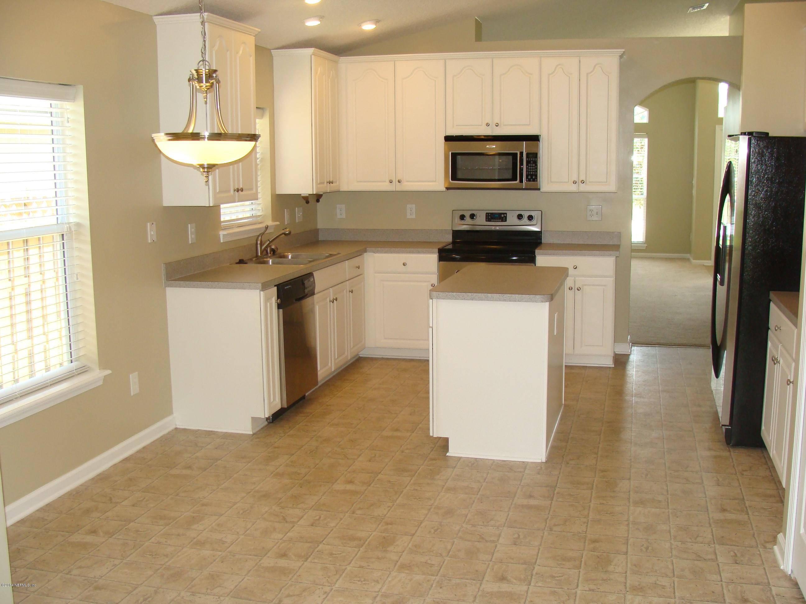 840 Crystal Spring Way St. Augustine, FL 32092 - Photo 3 of 6 a kitchen with a refrigerator and a stove top oven