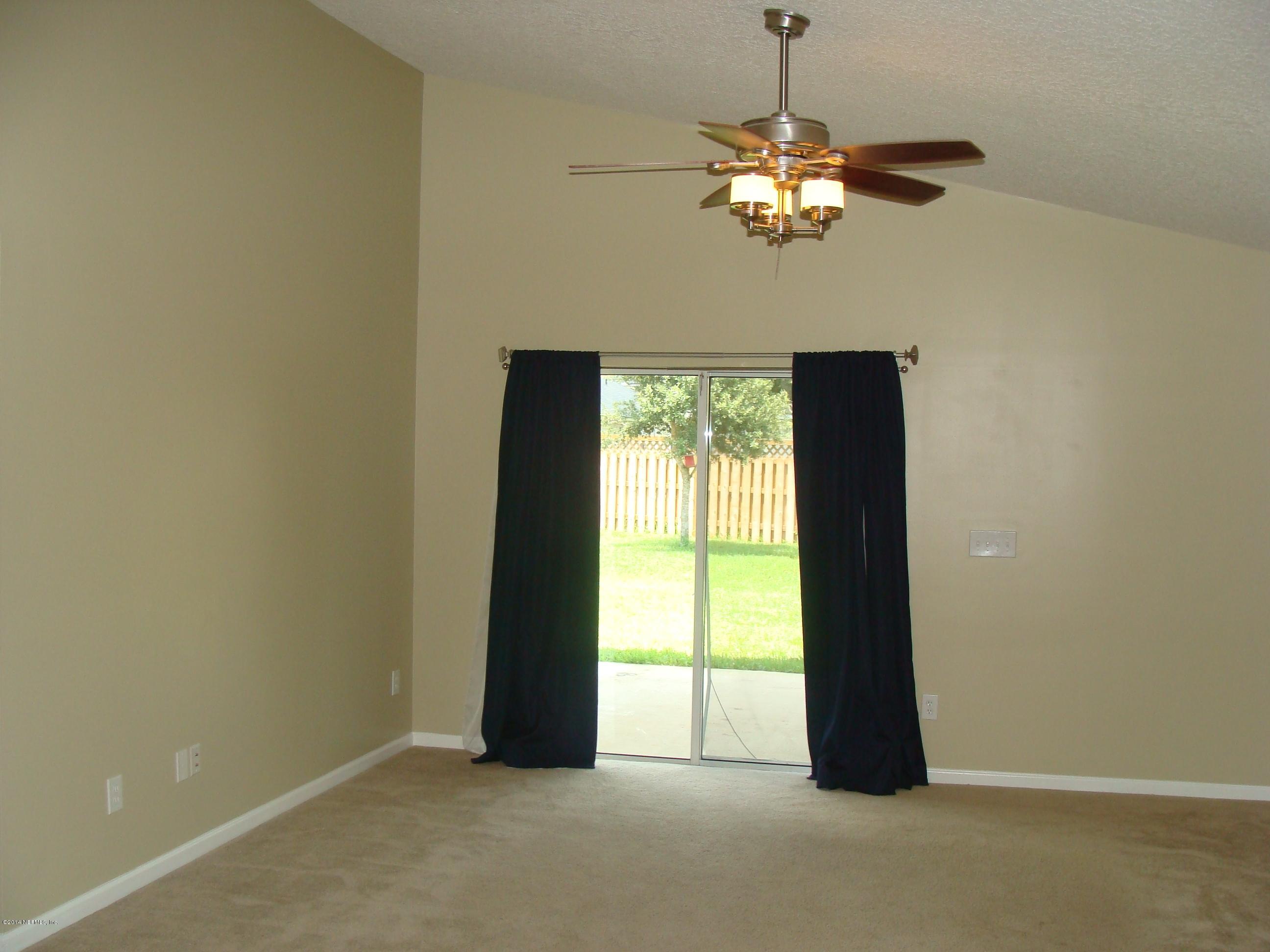 840 Crystal Spring Way St. Augustine, FL 32092 - Photo 4 of 6 a view of an empty room with a window