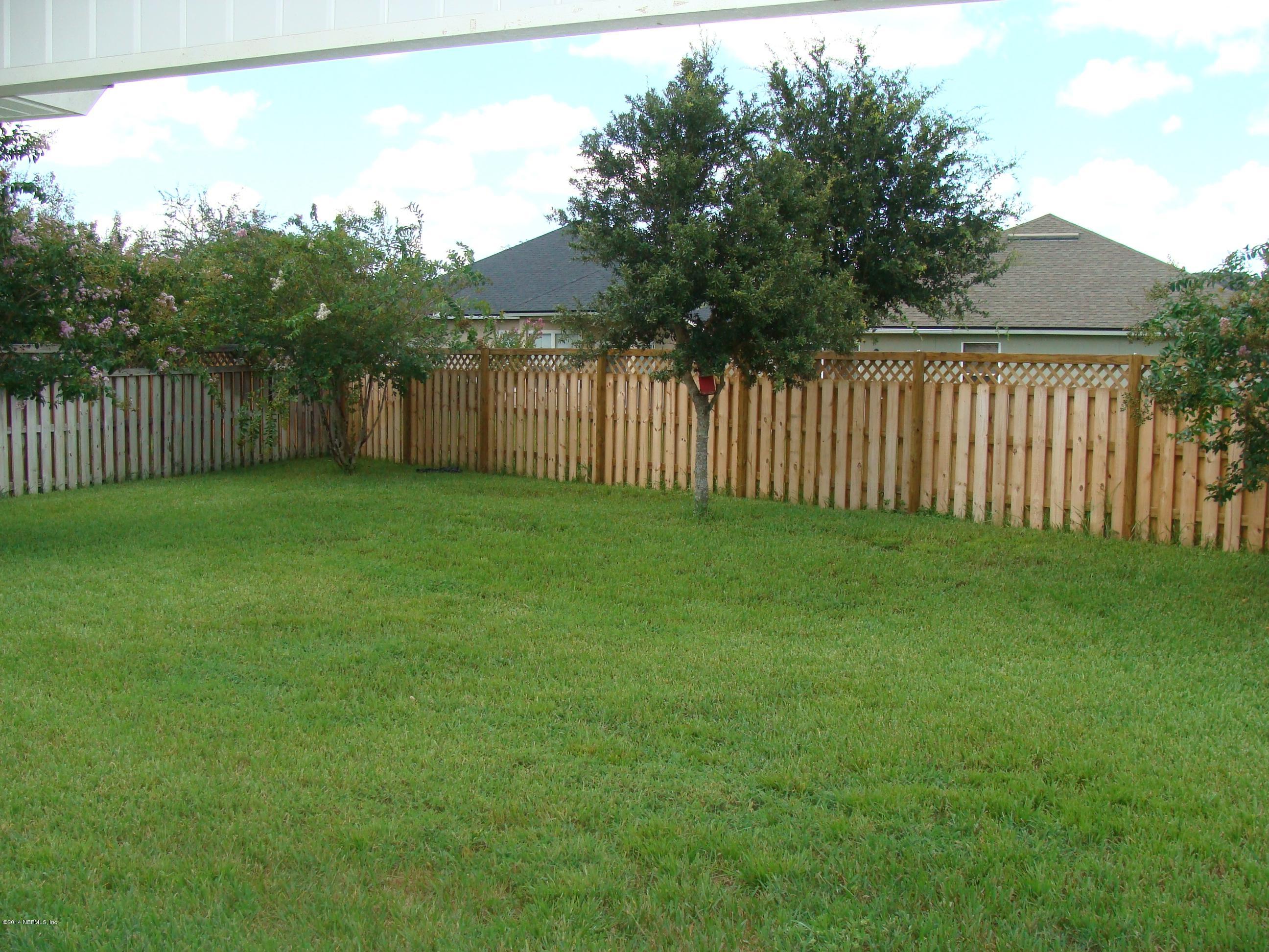 840 Crystal Spring Way St. Augustine, FL 32092 - Photo 6 of 6 a view of a backyard with a fence