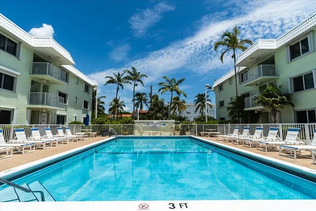 a swimming pool view with a outdoor seating space