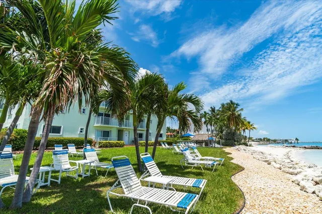 a view of backyard of house with outdoor seating