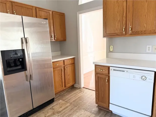 a kitchen with metallic refrigerator freezer and a dishwasher