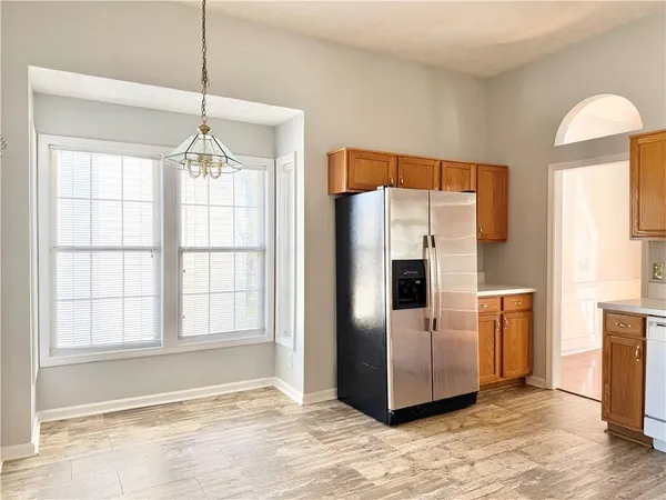 a view of a kitchen with a sink and a refrigerator
