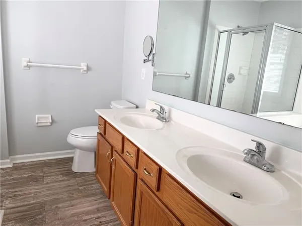 a bathroom with a double vanity sink and a mirror