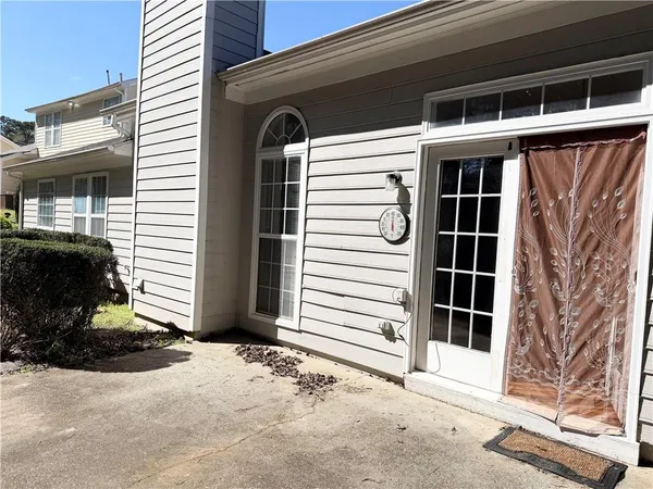 a view of a house with a door and wooden walls