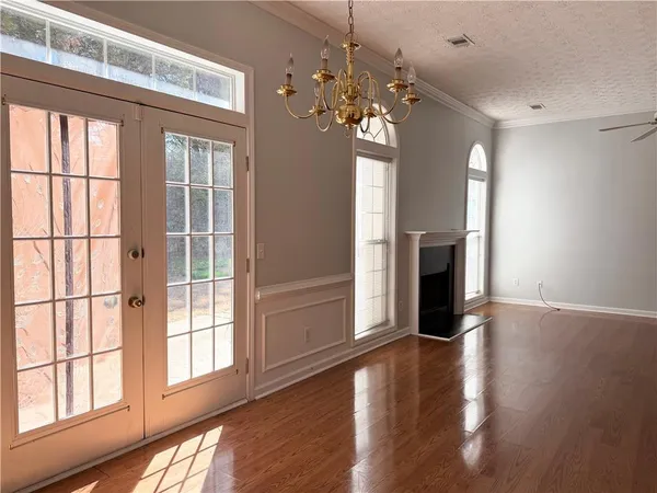 a view of a livingroom with a fireplace wooden floor and windows