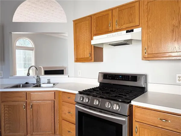 a kitchen with granite countertop a stove and a sink