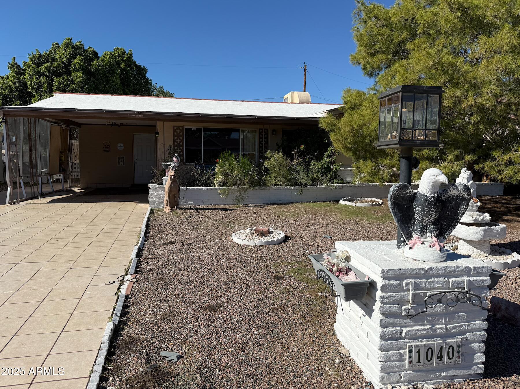1040 South Lawther Drive Apache Junction, AZ 85120 - Photo 1 of 1 a view of a house with backyard sitting area and garden