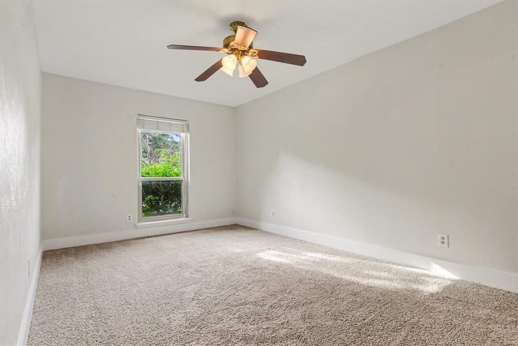 5926 Rosehill Road Garland, TX 75043 - Photo 17 of 26 an empty room with a window and a fan