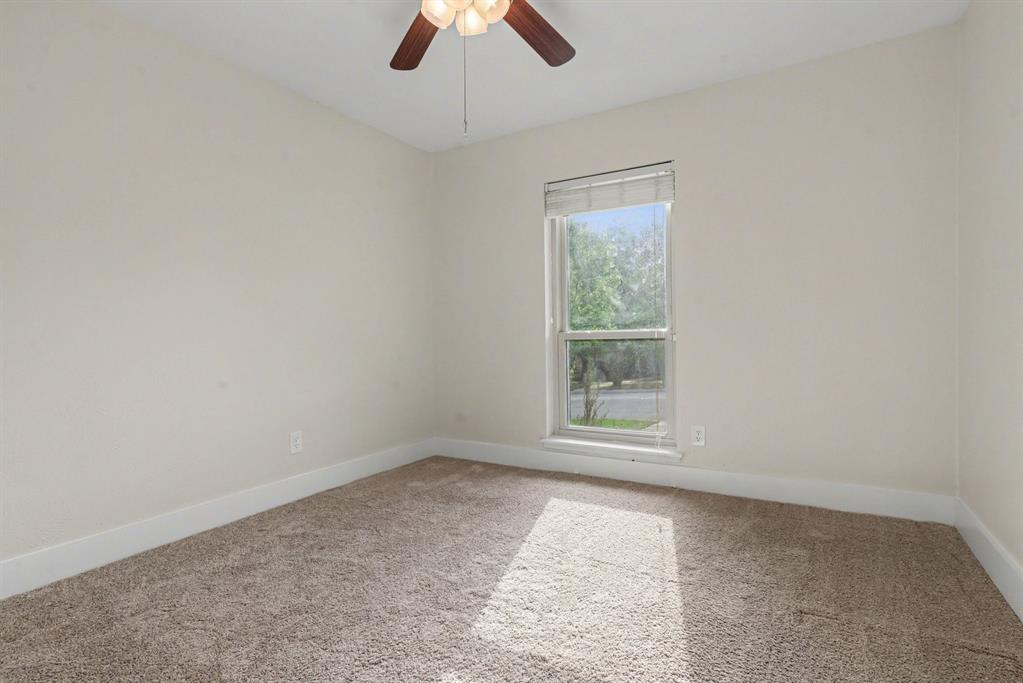 5926 Rosehill Road Garland, TX 75043 - Photo 19 of 26 an empty room with a window and a fan