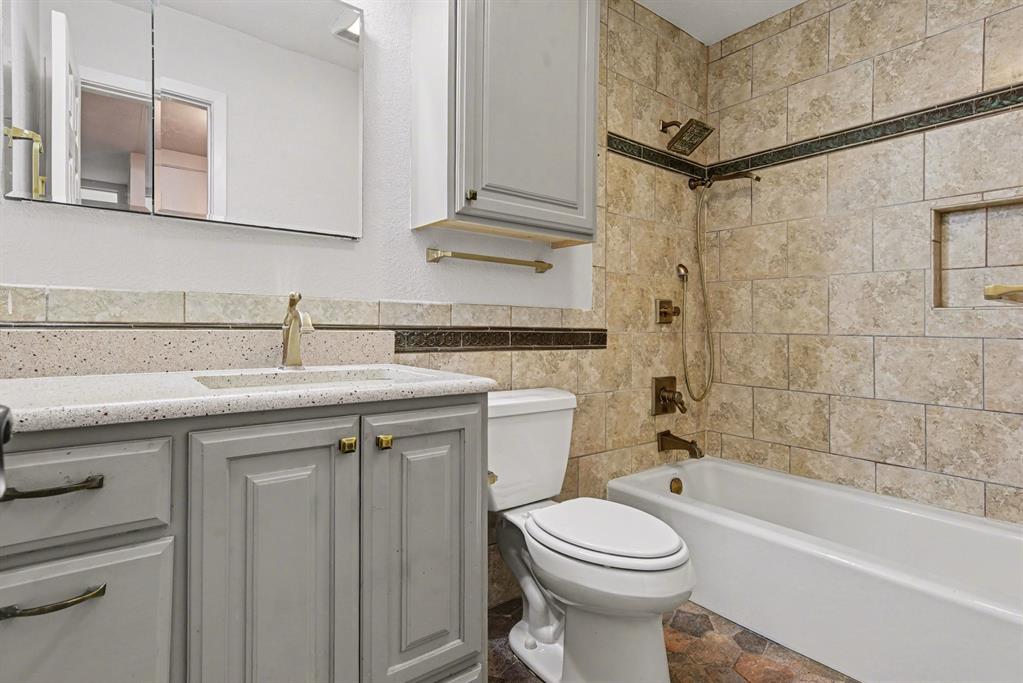 5926 Rosehill Road Garland, TX 75043 - Photo 23 of 26 a bathroom with a sink a toilet and bathtub