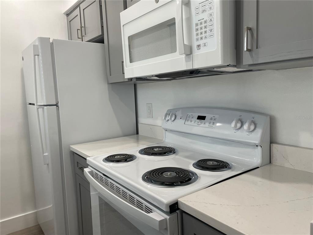 2003 Greenbriar Boulevard, Unit 16 Clearwater, FL 33763 - Photo 39 of 56 a kitchen with a stove and refrigerator
