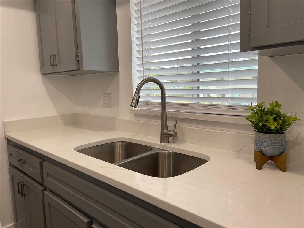 2003 Greenbriar Boulevard, Unit 16 Clearwater, FL 33763 - Photo 40 of 56 a kitchen with a sink and potted plant
