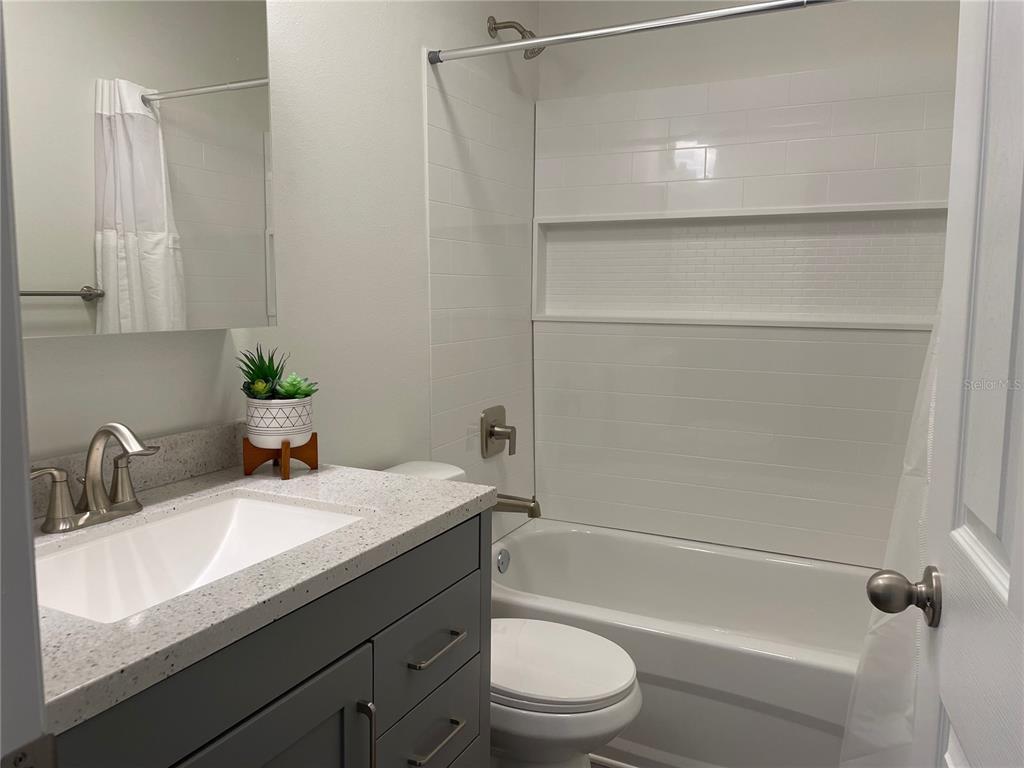 2003 Greenbriar Boulevard, Unit 16 Clearwater, FL 33763 - Photo 45 of 56 a bathroom with a sink a toilet and shower