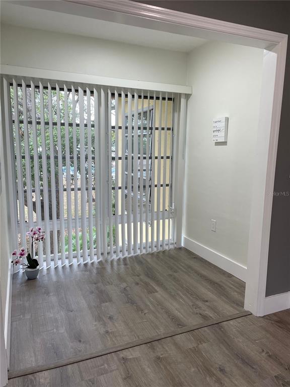 2003 Greenbriar Boulevard, Unit 16 Clearwater, FL 33763 - Photo 53 of 56 a view of an empty room with wooden floor