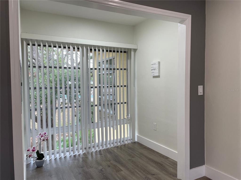 2003 Greenbriar Boulevard, Unit 16 Clearwater, FL 33763 - Photo 54 of 56 a view of a porch with wooden floor