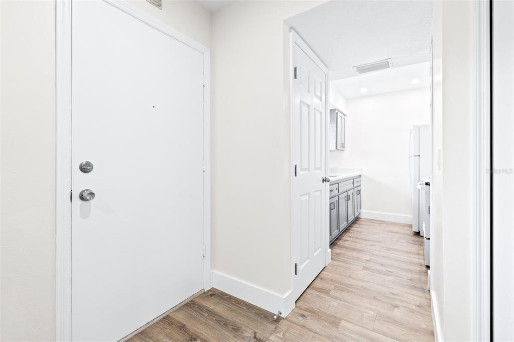 2003 Greenbriar Boulevard, Unit 16 Clearwater, FL 33763 - Photo 7 of 56 a view of a hallway with wooden floor