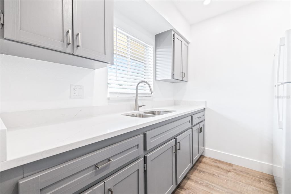 2003 Greenbriar Boulevard, Unit 16 Clearwater, FL 33763 - Photo 9 of 56 a kitchen with a sink and cabinets