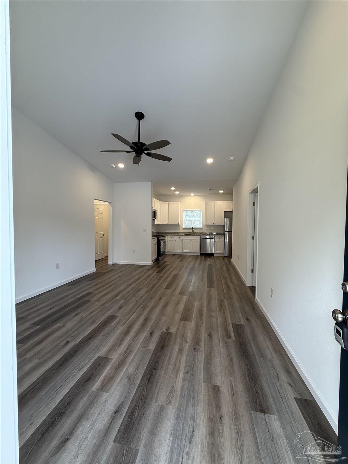 654 Nix Road Pensacola, FL 32506 - Photo 2 of 11 a view of empty room with wooden floor and fan