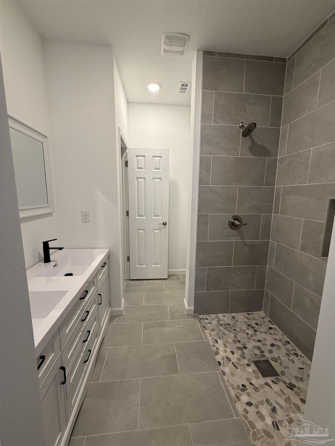 654 Nix Road Pensacola, FL 32506 - Photo 6 of 11 a bathroom with a sink a toilet and shower