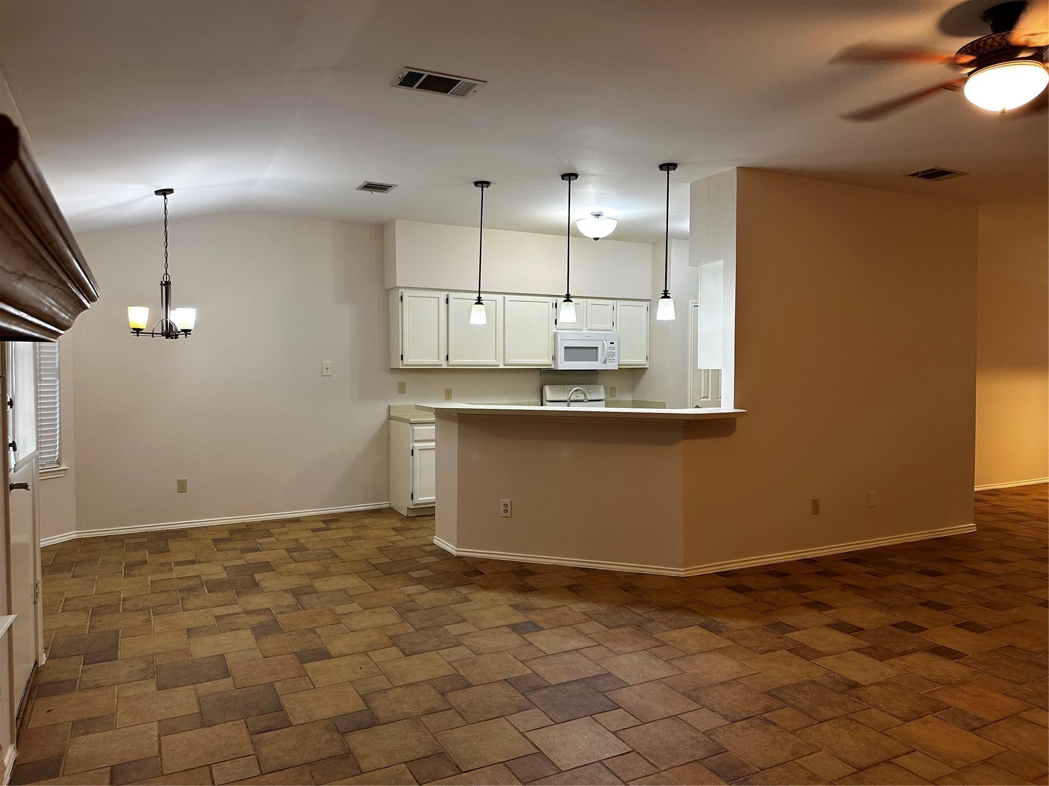 8007 Bounty Trail Austin, TX 78749 - Photo 16 of 32 An open layout blends kitchen functionality with adjacent living areas, all grounded by patterned tile.