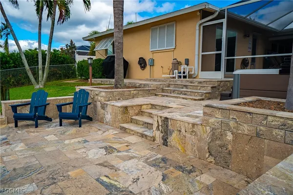 a view of house with yard outdoor seating and barbeque oven