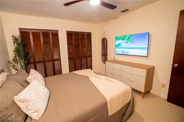 a bedroom with a bed and a large mirror