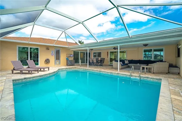 a view of a dining hall with furniture and a large window