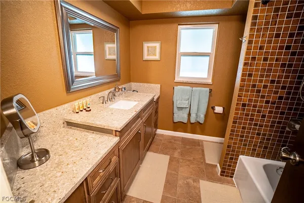 a bathroom with a sink a vanity and a mirror