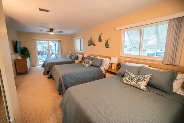 a bedroom with two beds and a large window