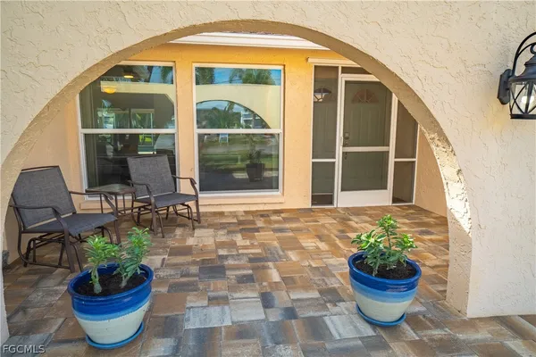 a front view of a house with a potted plant