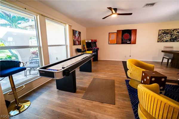a living room with furniture a rug and a large window