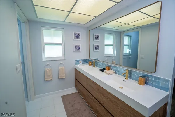 a bathroom with a sink and a mirror