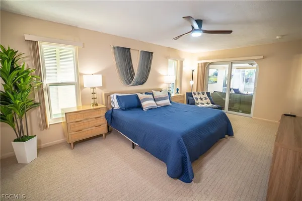 a bedroom with a large bed and a large window