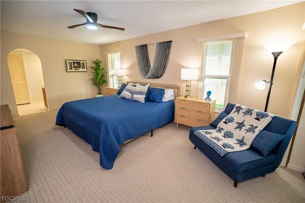 a bedroom with furniture and a flat screen tv