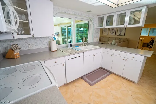 a kitchen with a sink stove and cabinets