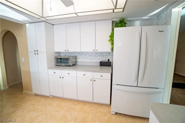 a white refrigerator freezer sitting in a kitchen