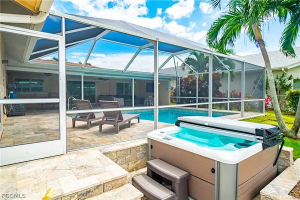 a view of a backyard with swimming pool and porch