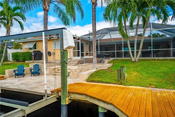 a view of a backyard with plants and patio